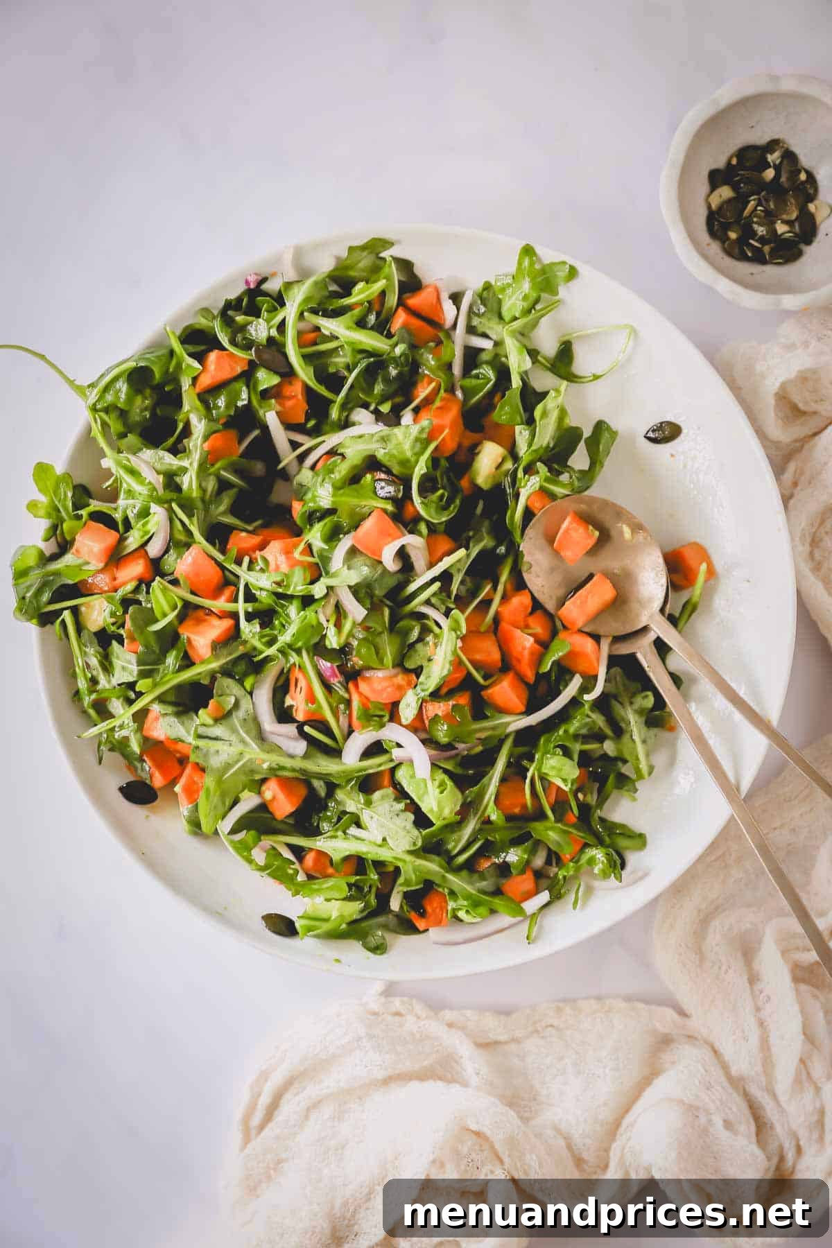 Creamy Sweet Potato Delight 8 Overhead image of a bountiful bowl of sweet potato salad with elegant serving spoons resting on the side, ready for sharing.