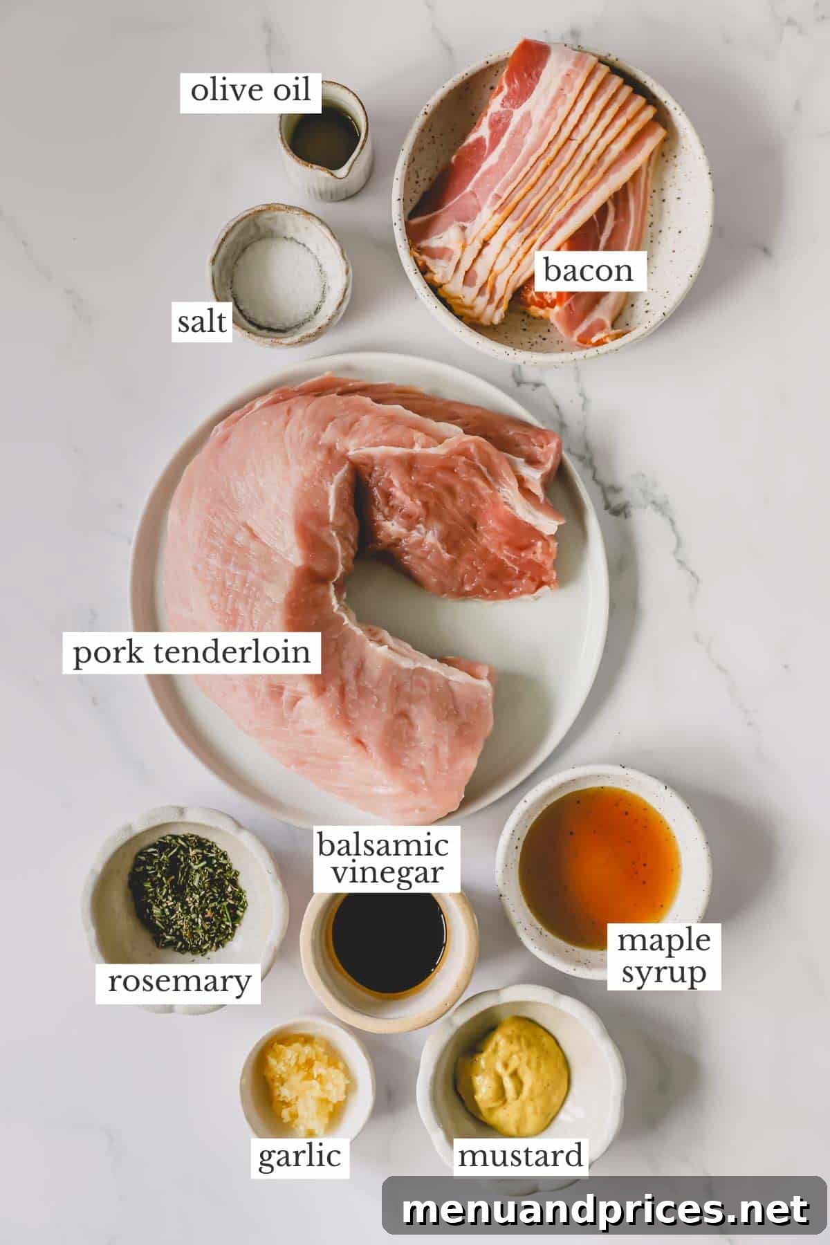 The Ultimate Bacon-Wrapped Pork Tenderloin 4 Ingredients needed to make a baked bacon wrapped tenderloin laid out on a table.