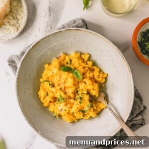 Express Golden Saffron Risotto 10 A bowl of saffron risotto with a fork sticking out, ready to be enjoyed.