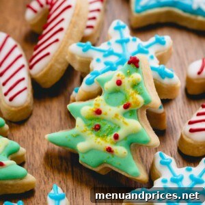 Iced Christmas sugar cookies in the shape of candy canes, Christmas trees, and snowflakes.