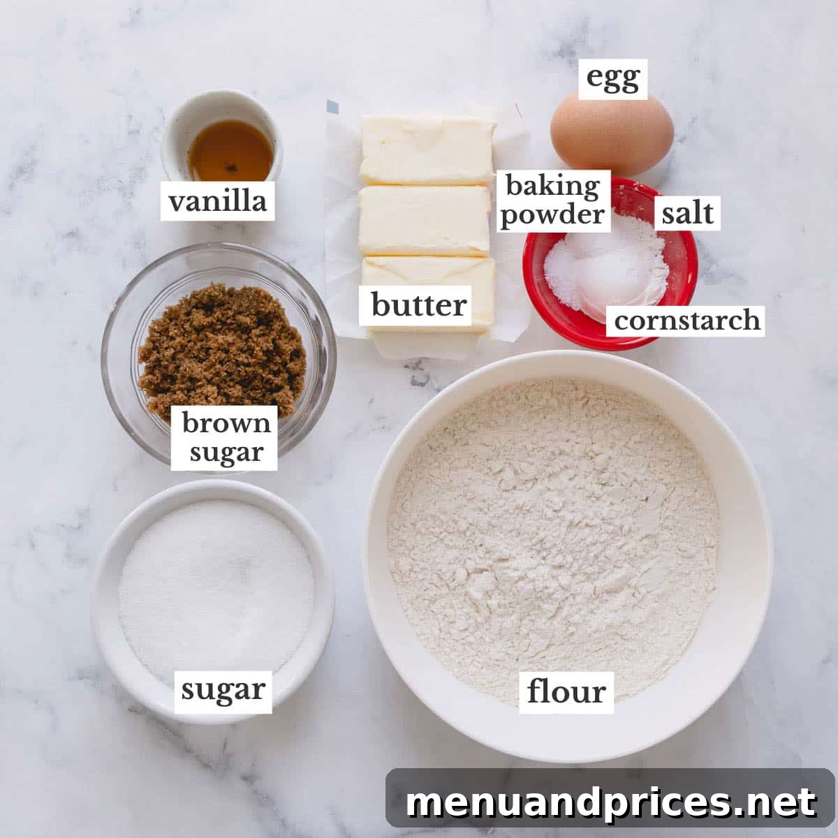 Festive Frosted Delights 4 All the necessary ingredients for vanilla sugar cookies, neatly arranged in individual bowls, ready for mixing.