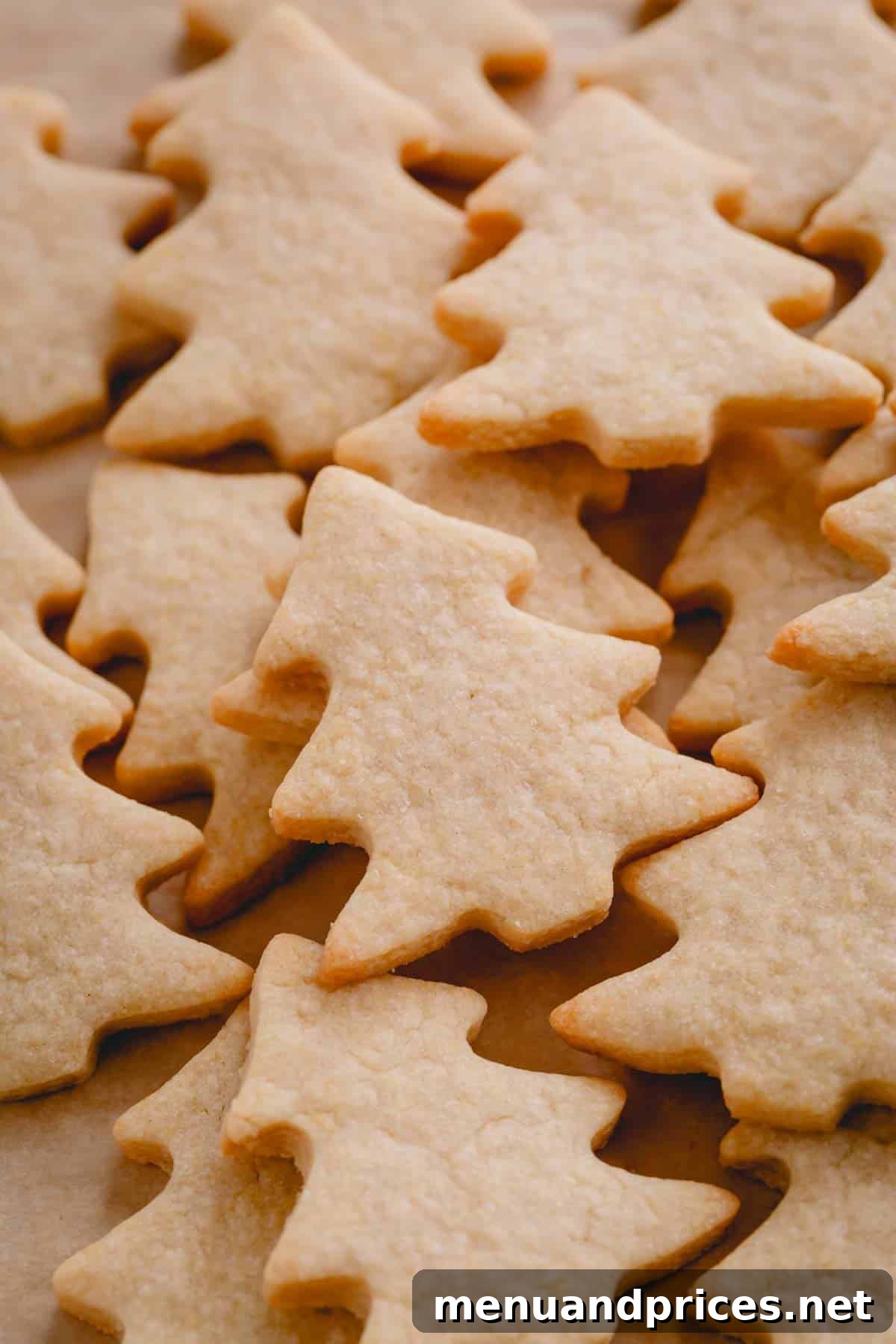 Festive Frosted Delights 8 Perfectly baked Christmas sugar cookies in the iconic shape of festive Christmas trees, ready for decoration.