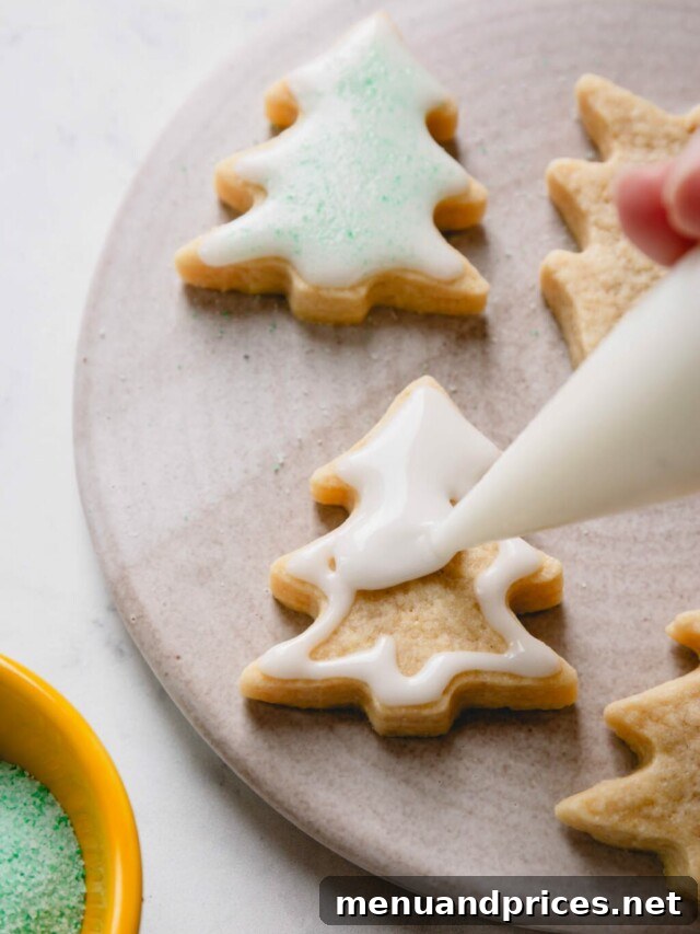 Festive Frosted Delights 9 A Christmas tree-shaped sugar cookie being expertly flooded with vibrant green royal icing.