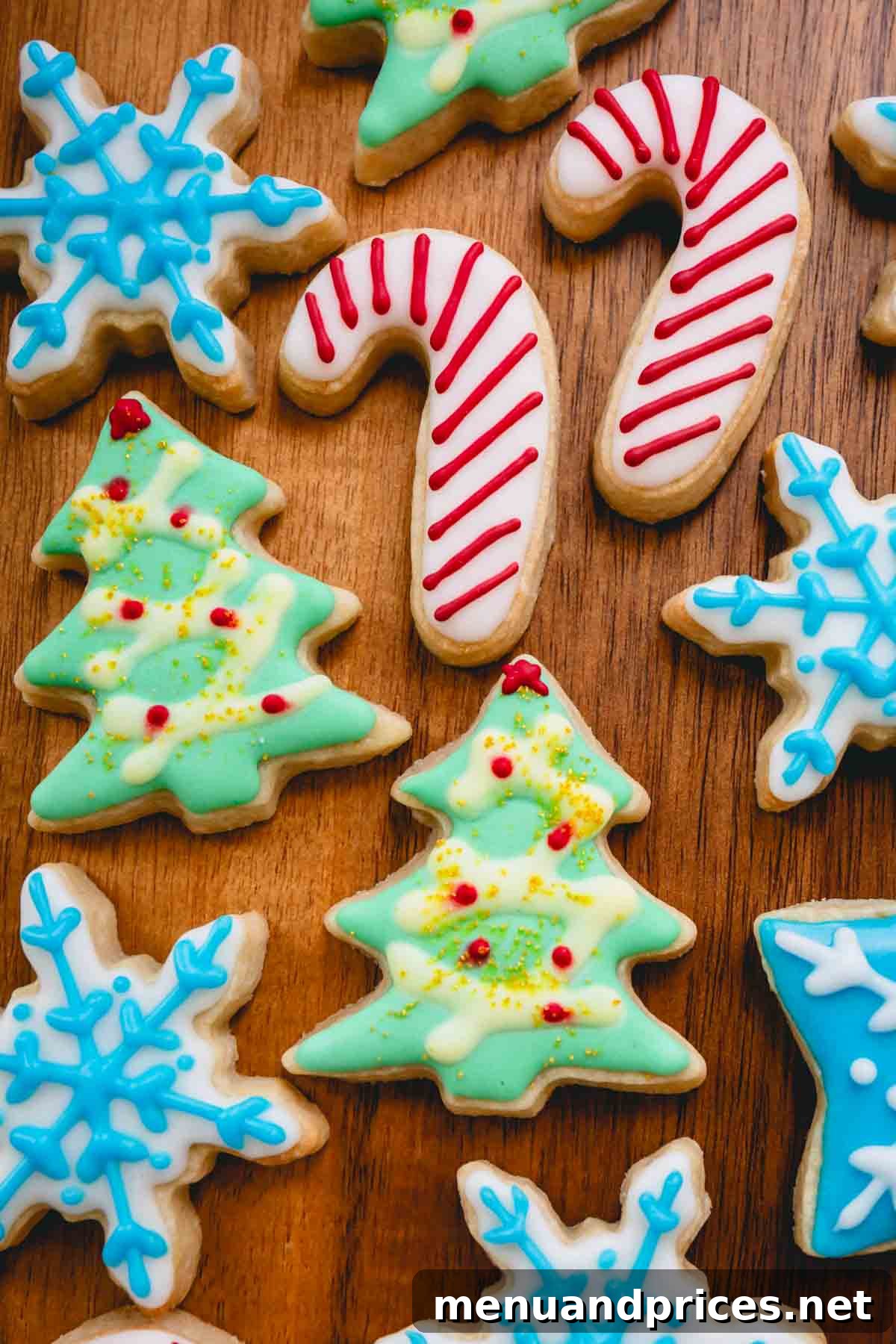 Festive Frosted Delights 10 A festive arrangement of beautifully decorated Christmas sugar cookies, featuring shapes like candy canes, Christmas trees, and snowflakes.