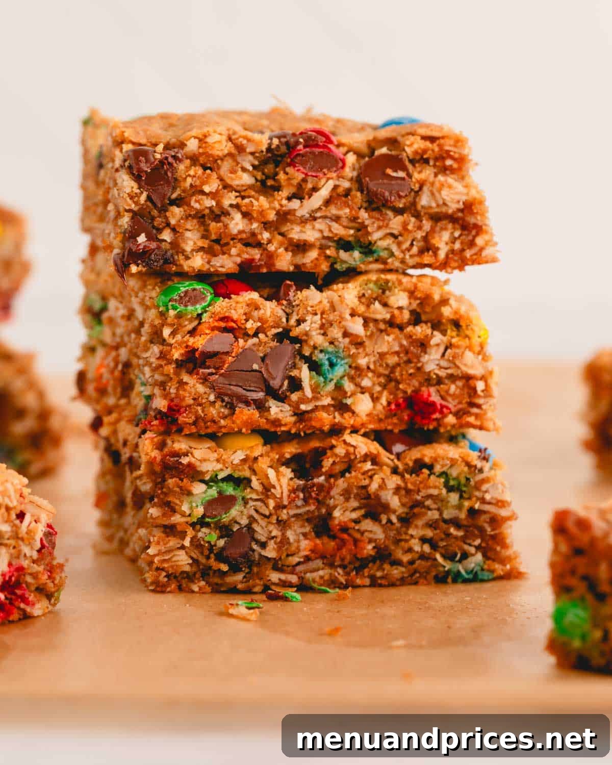 Kitchen Sink Cookie Squares 8 A neat stack of three flourless monster cookie bars, showing off their rich texture and mix-ins.