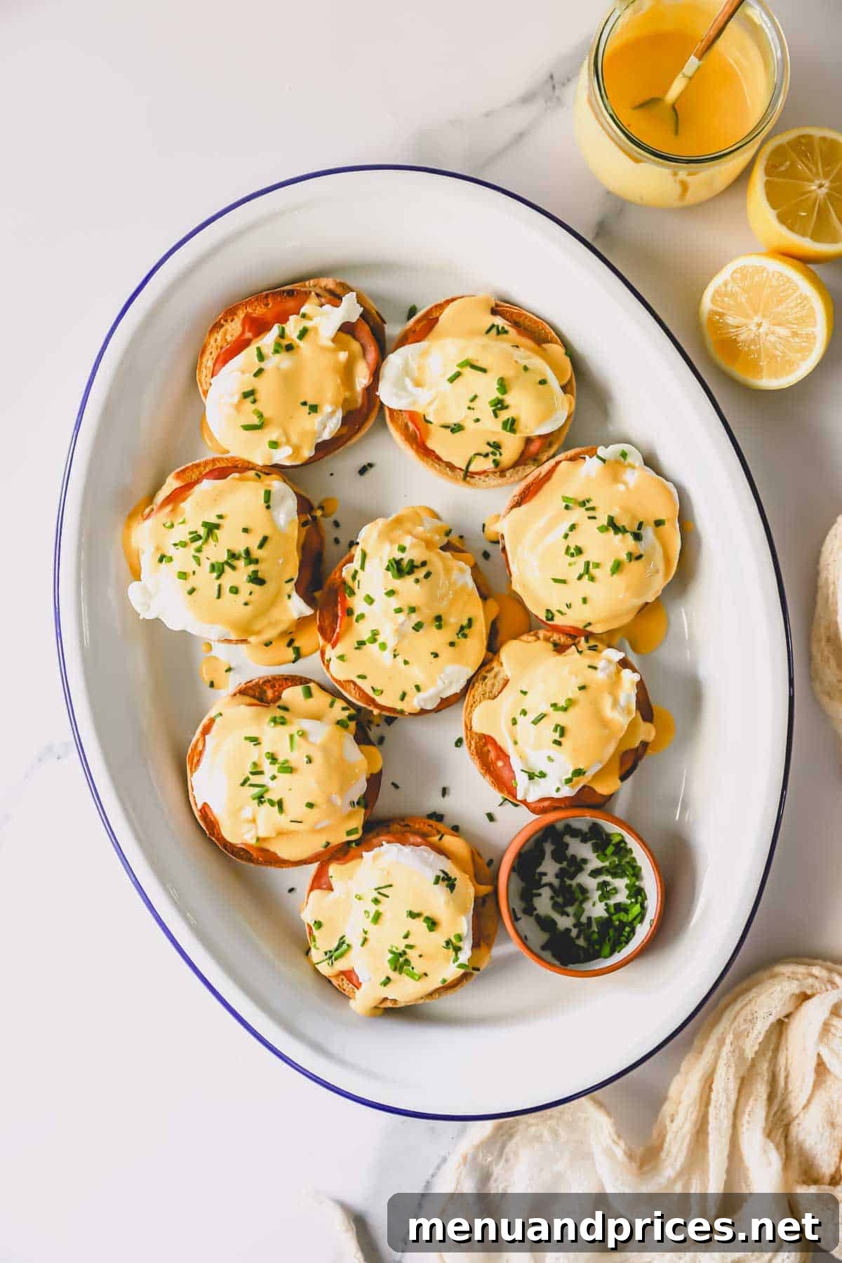 The Ultimate Eggs Benedict with Handcrafted Hollandaise 2 A platter of beautifully arranged Eggs Benedict, ready to be served for brunch.