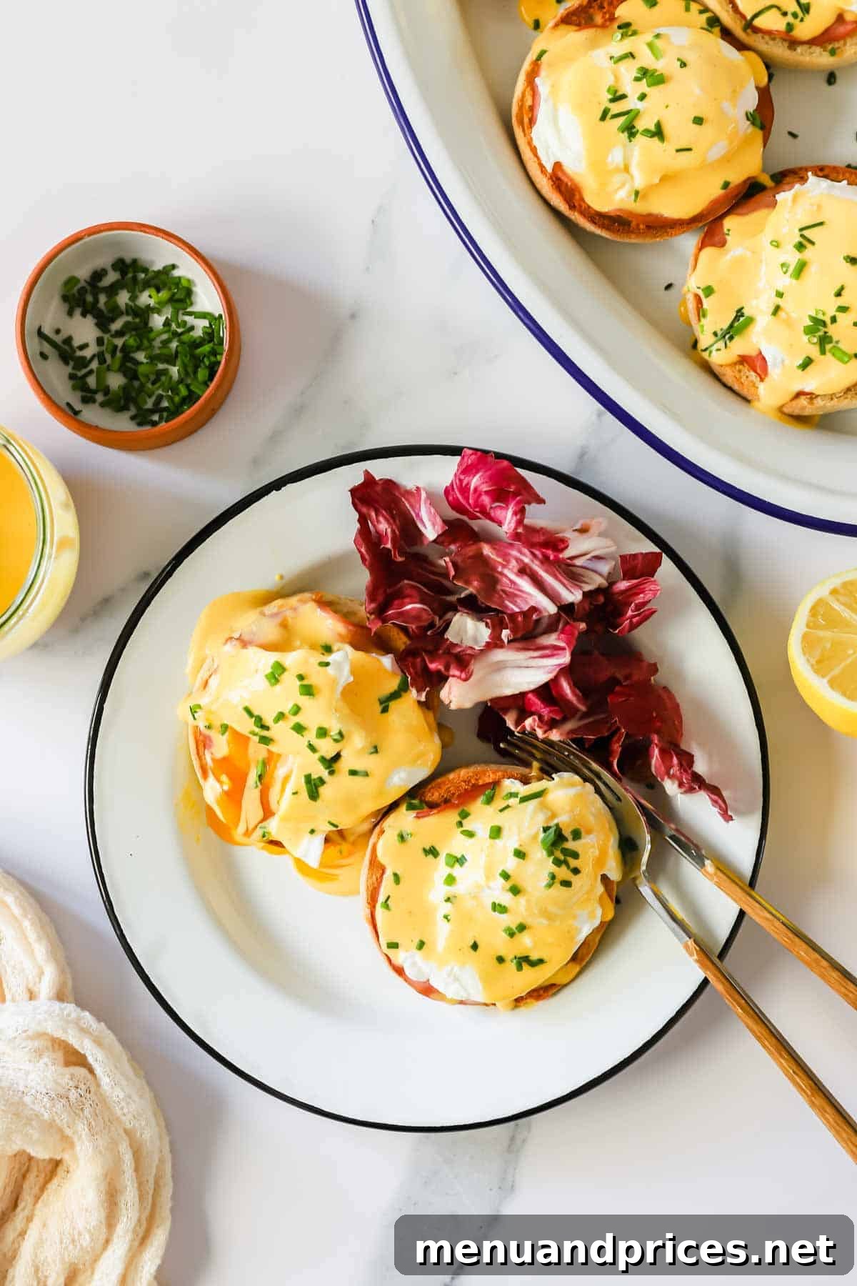 The Ultimate Eggs Benedict with Handcrafted Hollandaise 3 A beautifully plated dish of Eggs Benedict with a side of vibrant red cabbage, showcasing the golden hollandaise and perfectly poached egg.