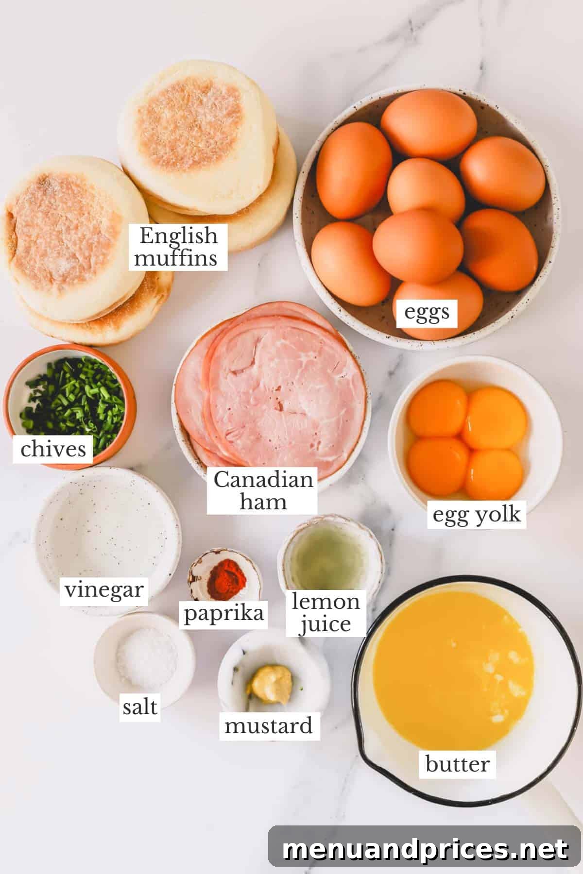 The Ultimate Eggs Benedict with Handcrafted Hollandaise 4 Ingredients for Eggs Benedict laid out on a table, including eggs, Canadian bacon, English muffins, and hollandaise sauce ingredients.