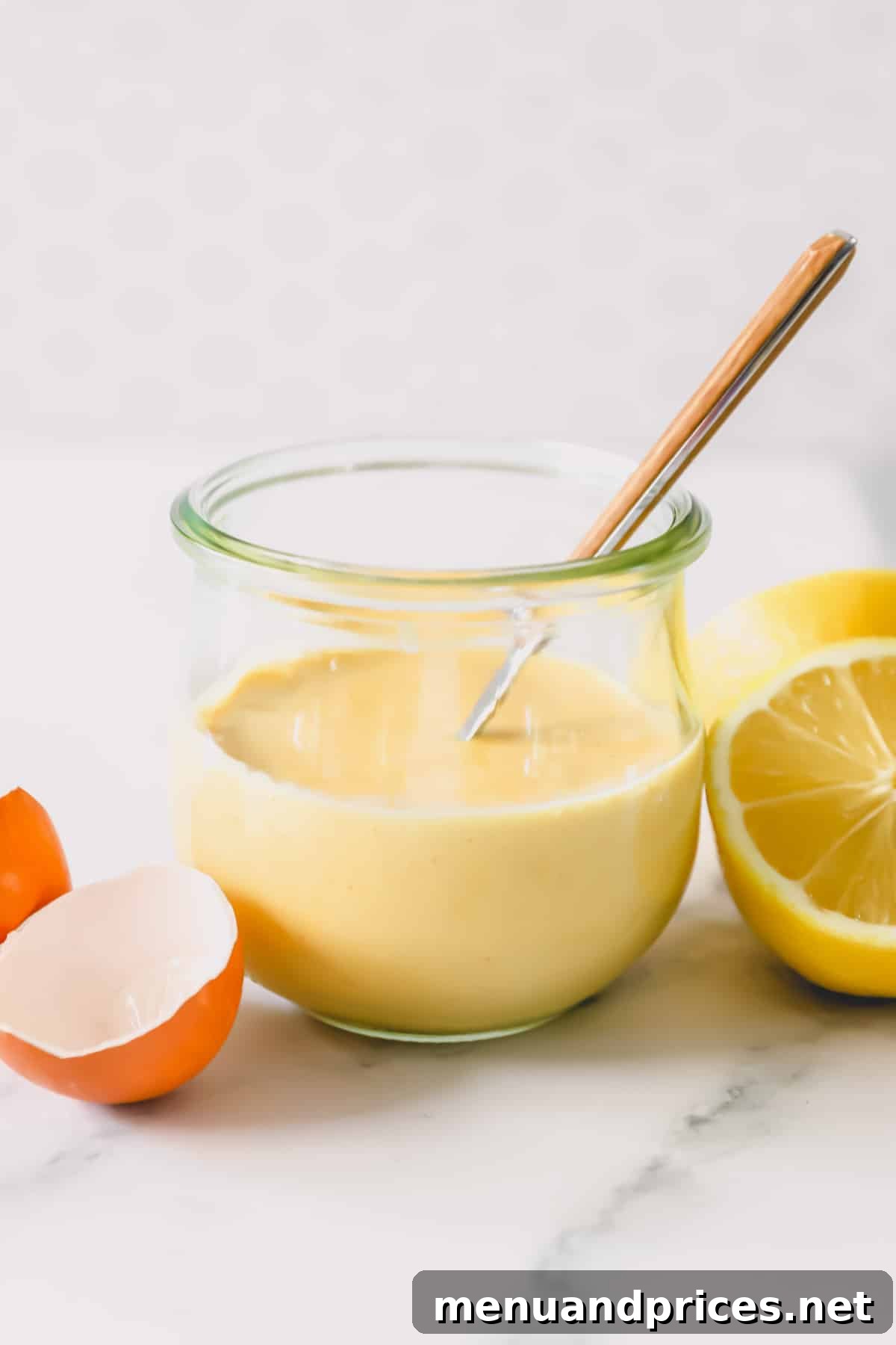 The Ultimate Eggs Benedict with Handcrafted Hollandaise 6 A glass jar filled with freshly made, vibrant yellow hollandaise sauce.
