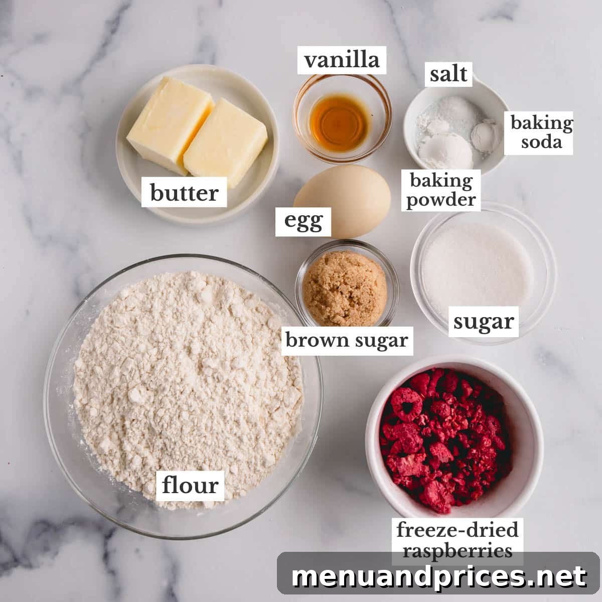 Raspberry Dream Cookies 4 Assortment of ingredients laid out on a table for making raspberry sugar cookies, including flour, butter, sugar, and freeze-dried raspberries.