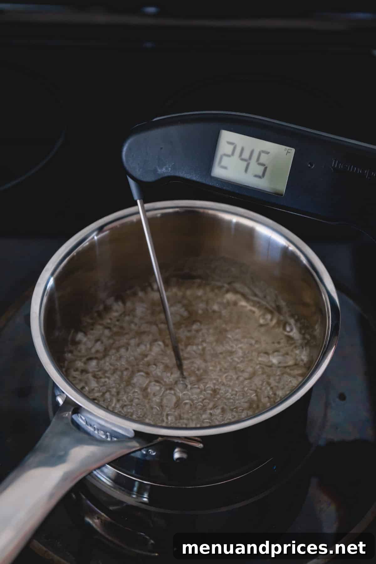 Authentic Italian Tiramisu 5 A small saucepan with boiling sugar syrup, a thermometer clearly indicating a temperature of 245 degrees Fahrenheit, illustrating the critical tempering step for the tiramisu filling.