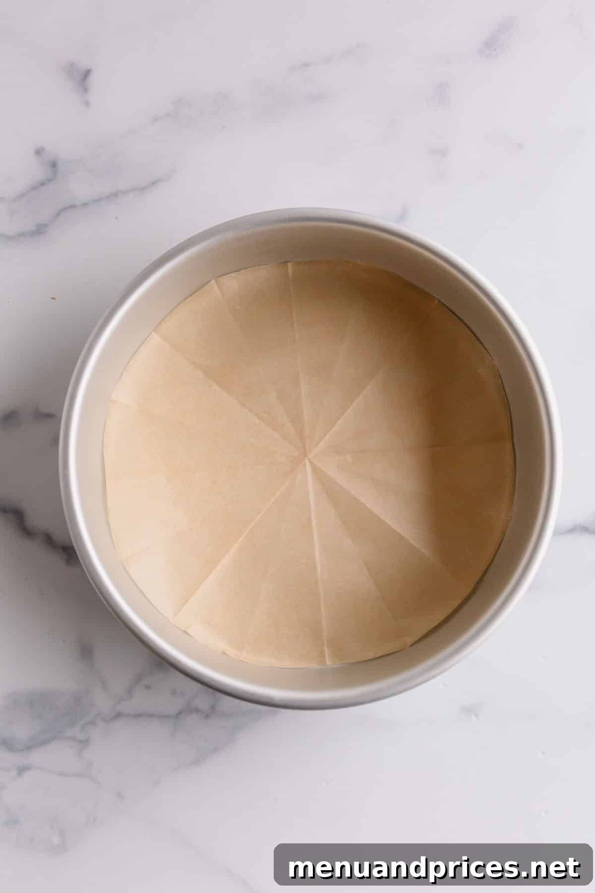 Achieving the Ideal Parchment Fit for Round Cake Pans 6 A round cake pan flawlessly lined with the freshly cut parchment paper, showcasing a perfect fit.