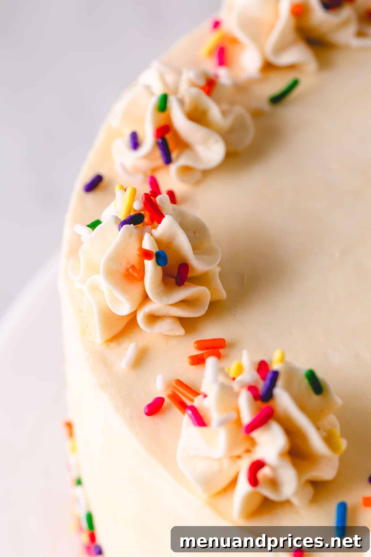 Classic Vanilla Russian Buttercream 3 A beautifully decorated cake adorned with smooth vanilla Russian buttercream and colorful sprinkles, ready for celebration and serving.