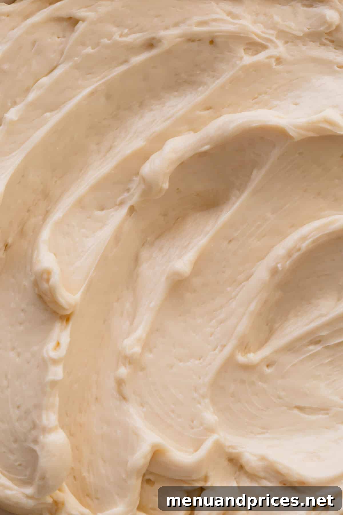 Classic Vanilla Russian Buttercream 7 A large bowl of freshly made vanilla Russian buttercream frosting, showcasing its beautiful smooth and creamy texture, ready for use.