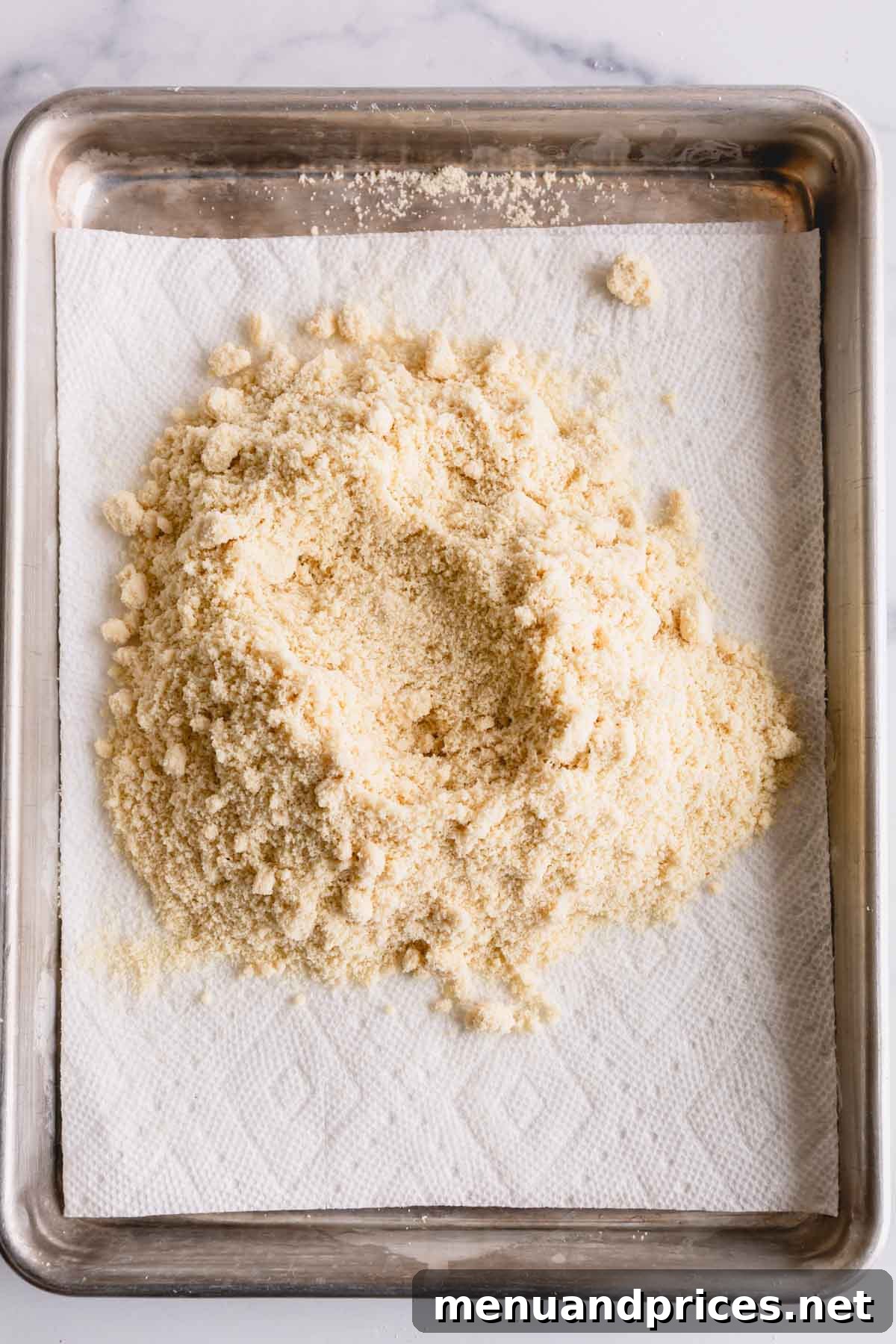 Mastering Dry Almond Flour: From Oily to Optimal 5 Almond flour thinly spread on a baking sheet lined with several layers of paper towel.
