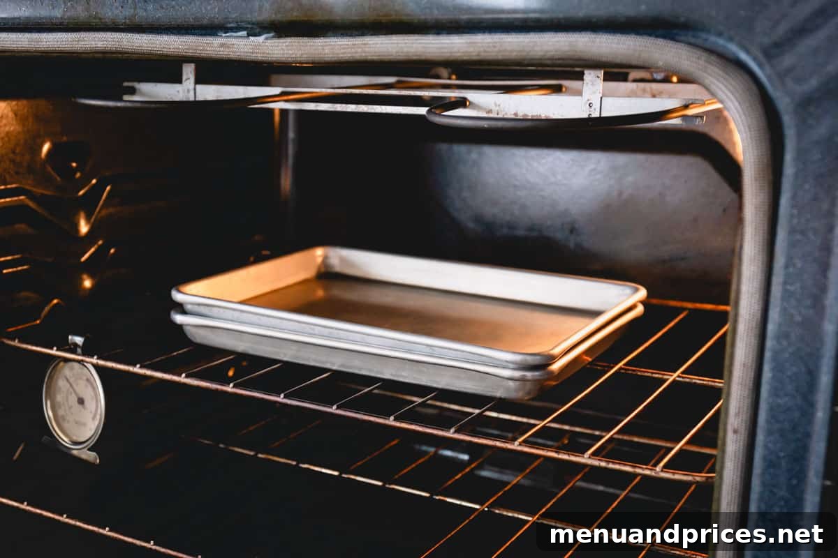Mastering Dry Almond Flour: From Oily to Optimal 7 Two baking sheets, with almond flour sandwiched within, gently baking in the oven.