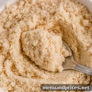 Mastering Dry Almond Flour: From Oily to Optimal 10 A close-up image of almond flour in a white bowl, representing the primary ingredient.