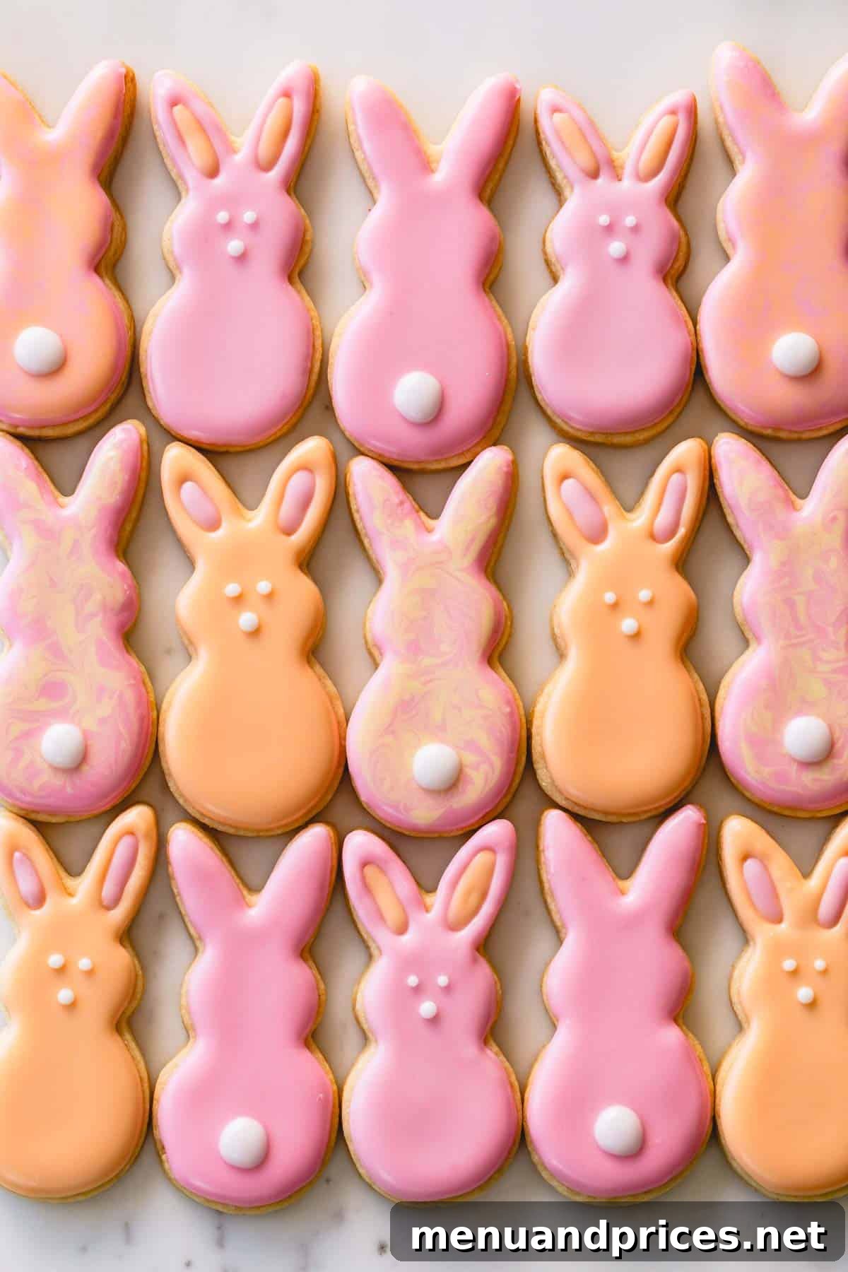 A charming close-up of pink and orange Easter sugar cookie bunnies, beautifully decorated and ready for display.