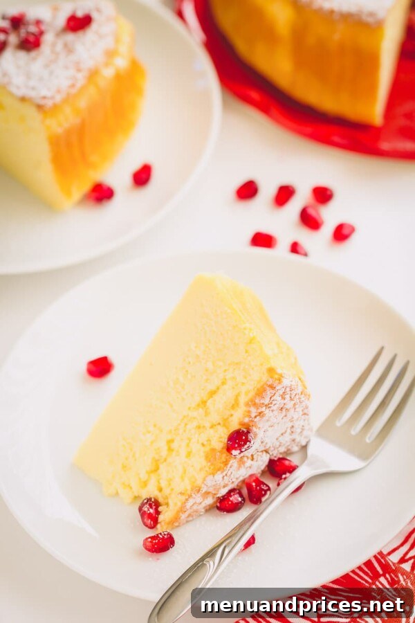A serving of soufflé cheesecake with a generous topping of fresh pomegranate seeds.