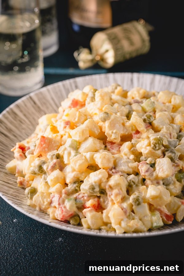 Timeless Russian Olivier 2 Classic Russian potato salad, also known as Olivier Salad, served beautifully on a platter, ready for a festive gathering.