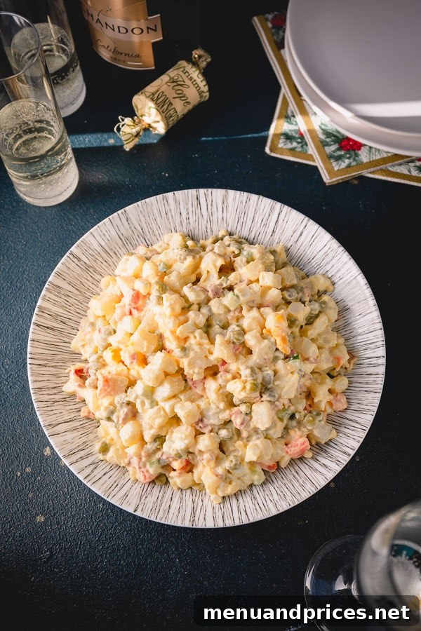 Timeless Russian Olivier 3 An inviting overhead shot of Olivier Salad, or Russian potato salad, in a large serving dish, showcasing its colorful ingredients.