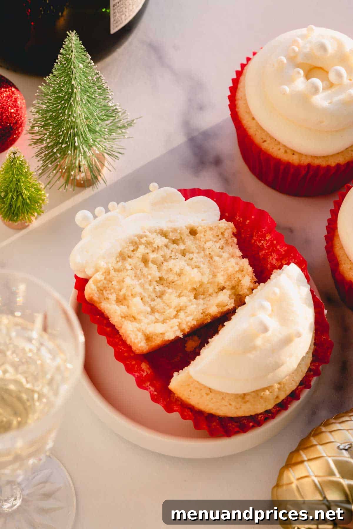 Effortless Leftover Bubbly Treats 11 A champagne cupcake perfectly cut in half, revealing its moist, airy texture and delicate crumb.