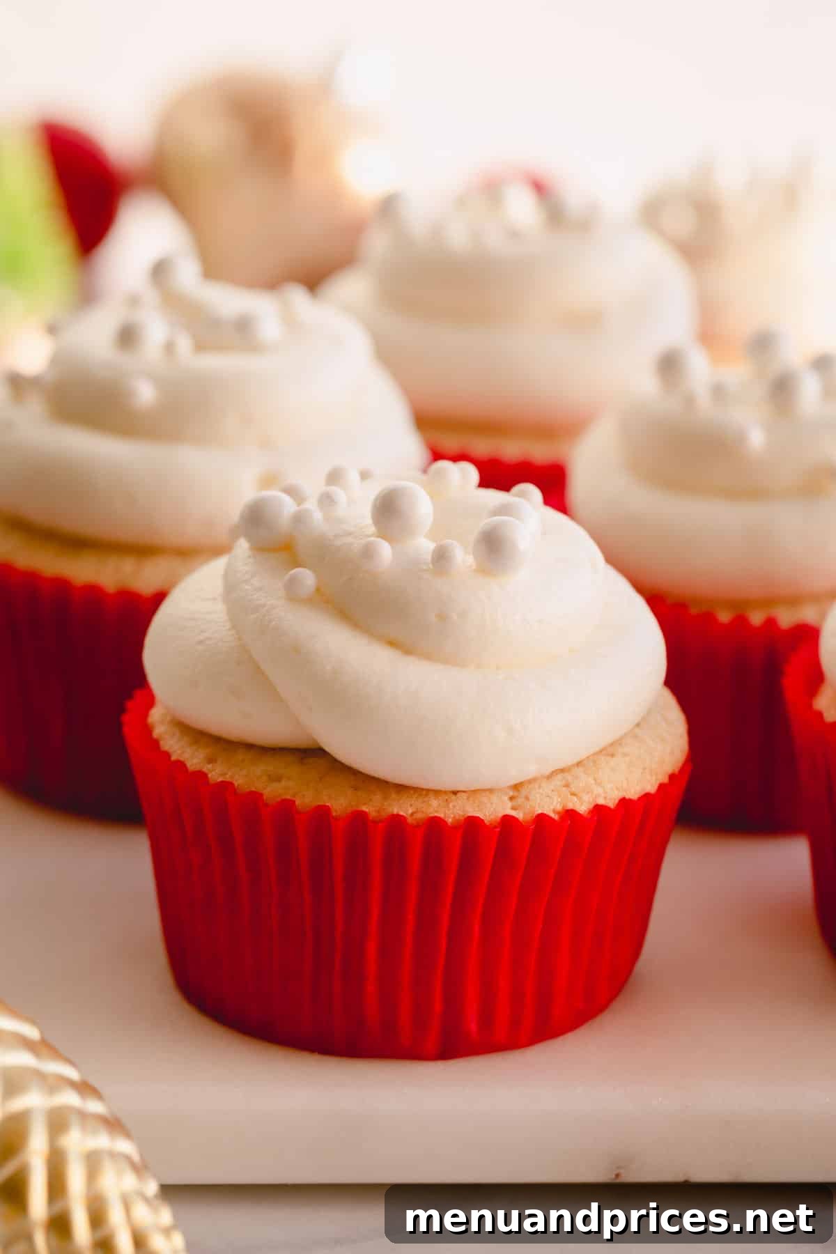 Effortless Leftover Bubbly Treats 10 A beautifully frosted champagne cupcake with white frosting and delicate pearl sprinkles.