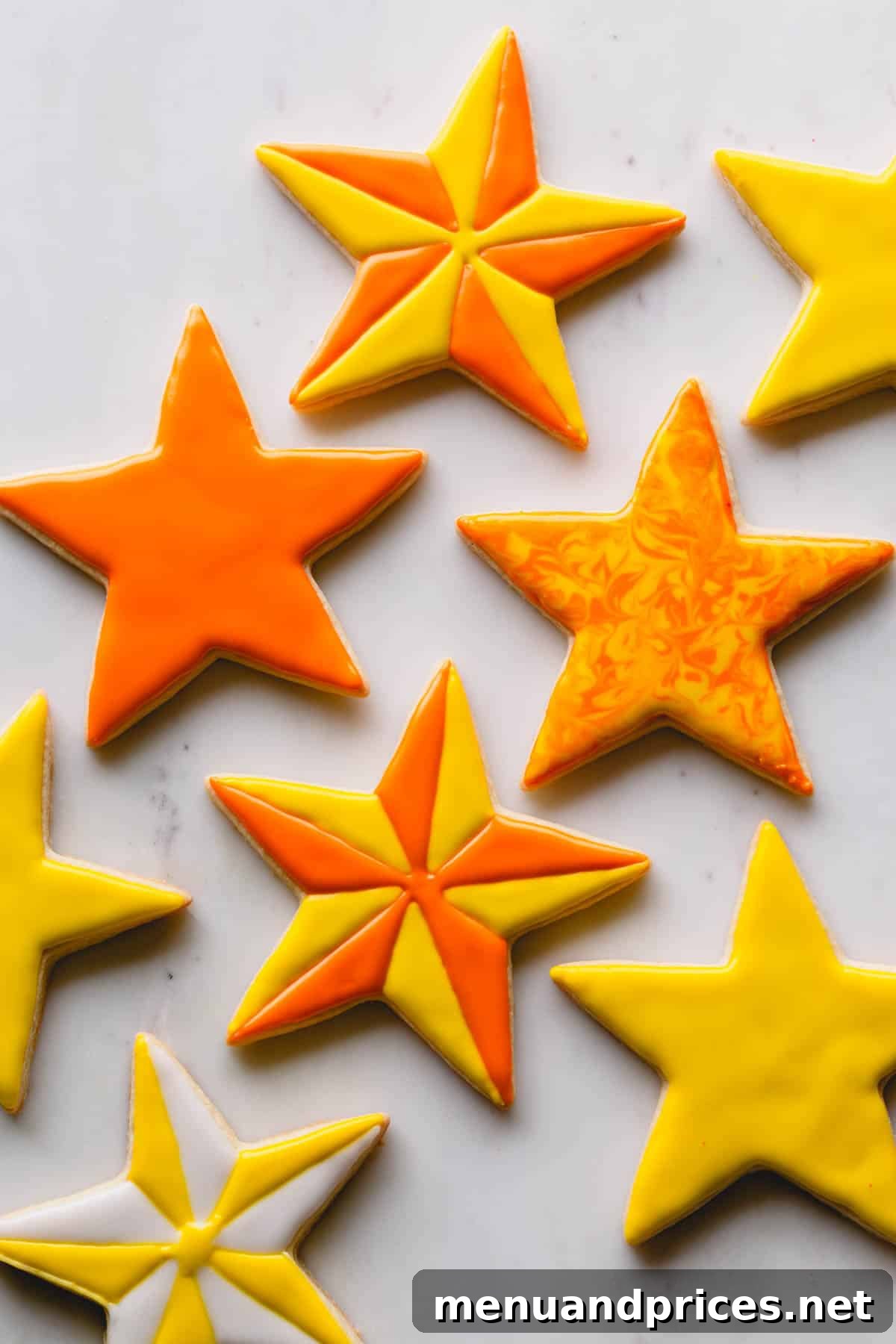 Whimsical yellow and orange star-shaped sugar cookies, meticulously decorated with colorful icing, displayed against a clean white background, highlighting playful baking possibilities.