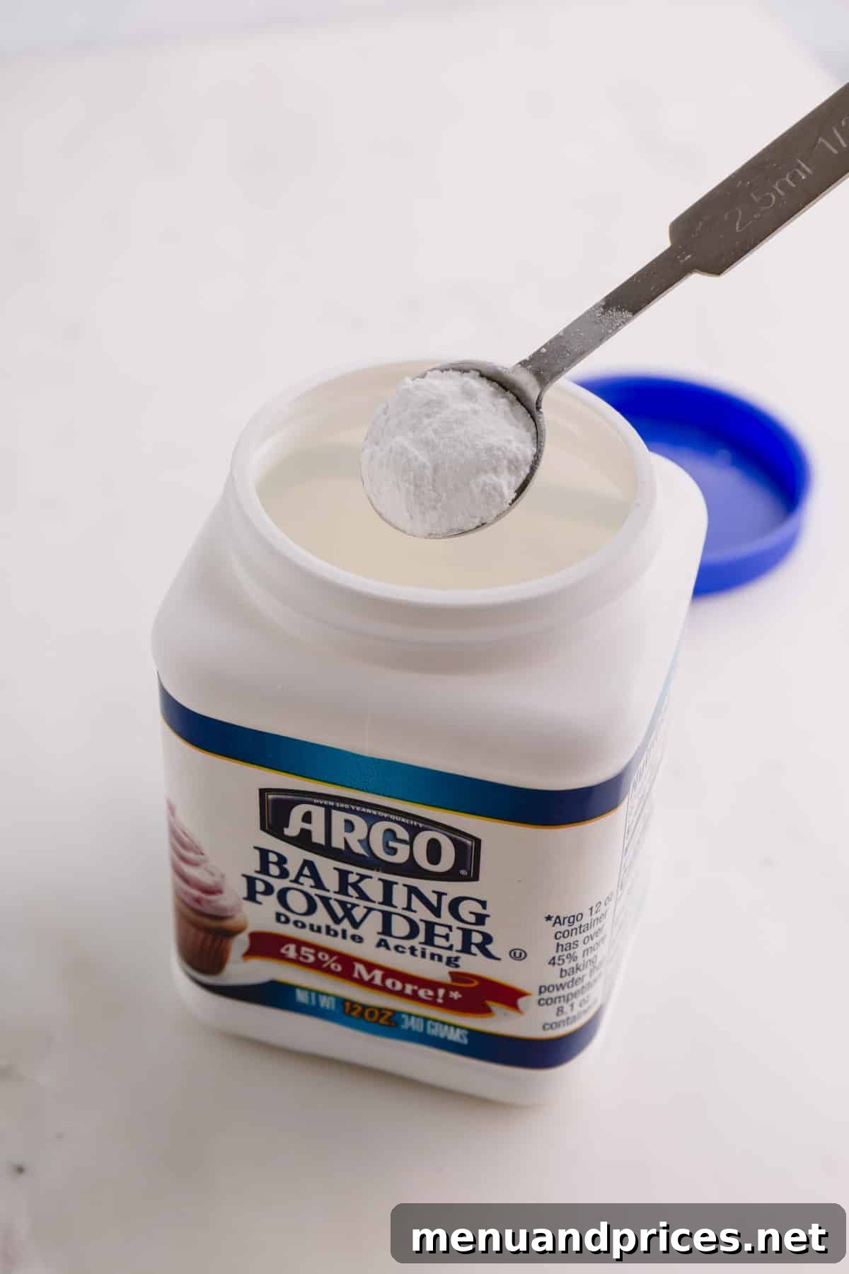 Baking Soda vs Baking Powder: Unraveling the Mystery 4 A container of baking powder with a spoonful.