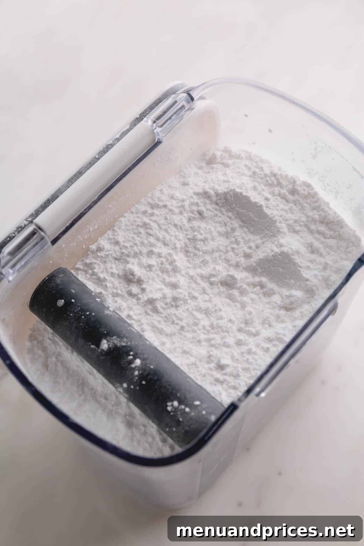 A container of powdered sugar, essential for smooth frostings and decorative dusting.