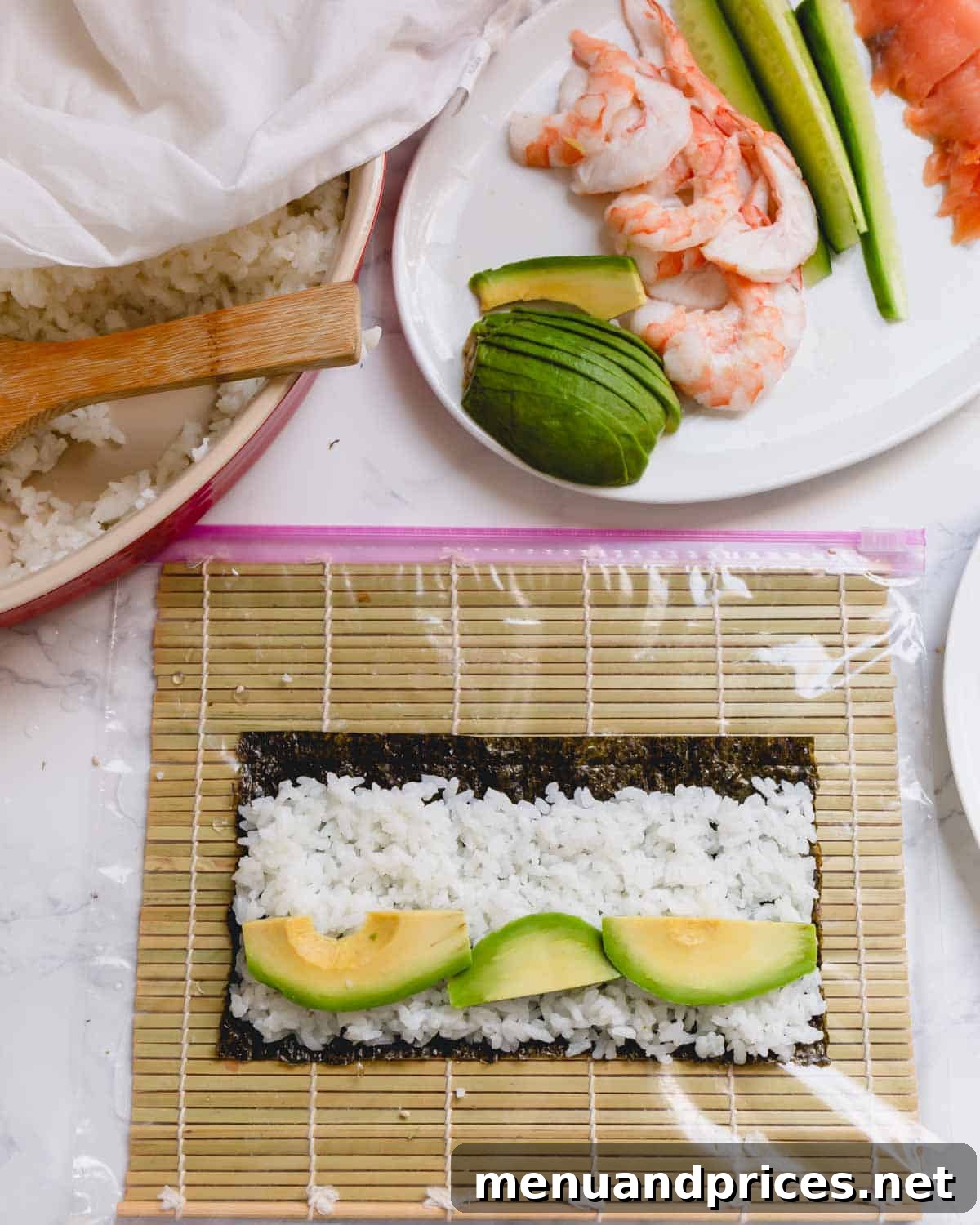 Crafting Delicious Sushi at Home 6 Nori sheet with sushi rice and avocado slices on a bamboo mat, ready for rolling.