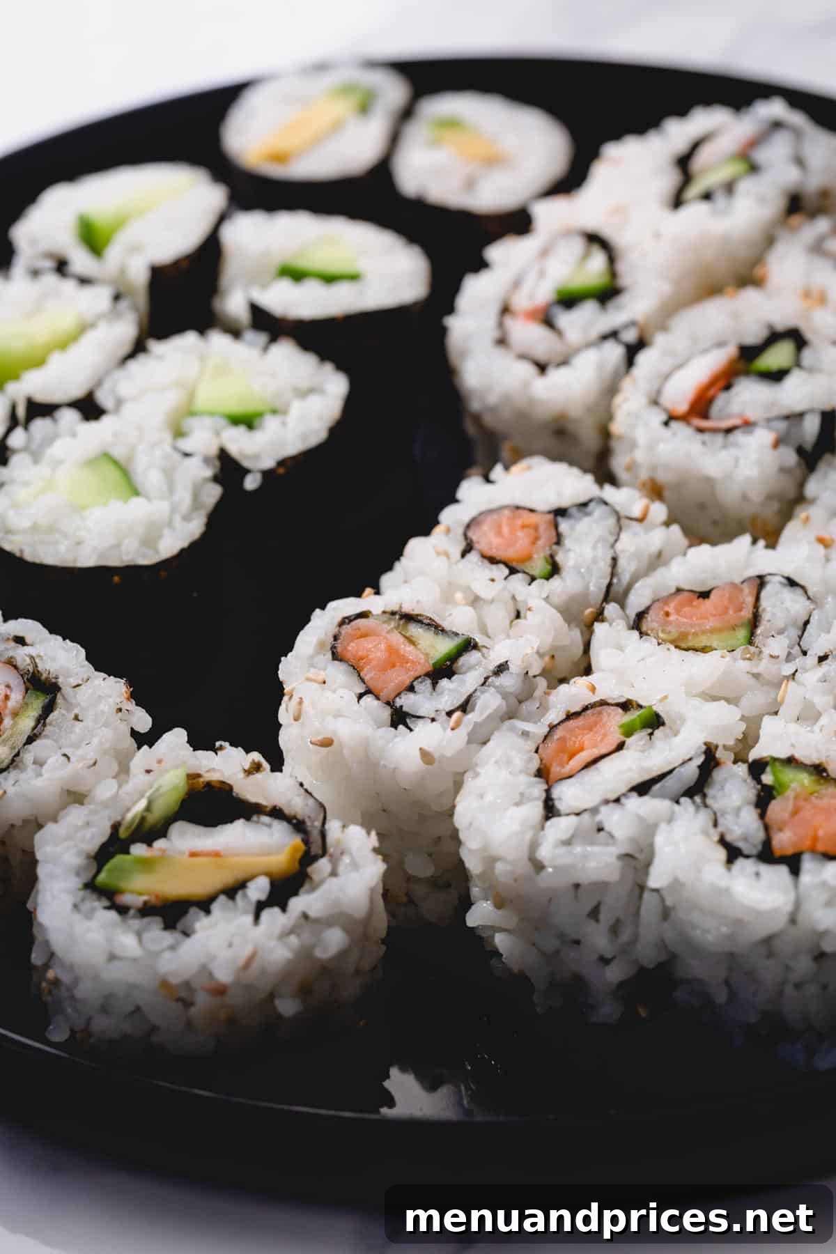 Crafting Delicious Sushi at Home 7 Variety of homemade sushi rolls on a black round platter, showcasing different fillings and inside-out techniques.