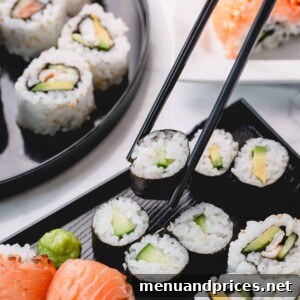 Crafting Delicious Sushi at Home 9 Cucumber rolls with one piece picked up with chopsticks.