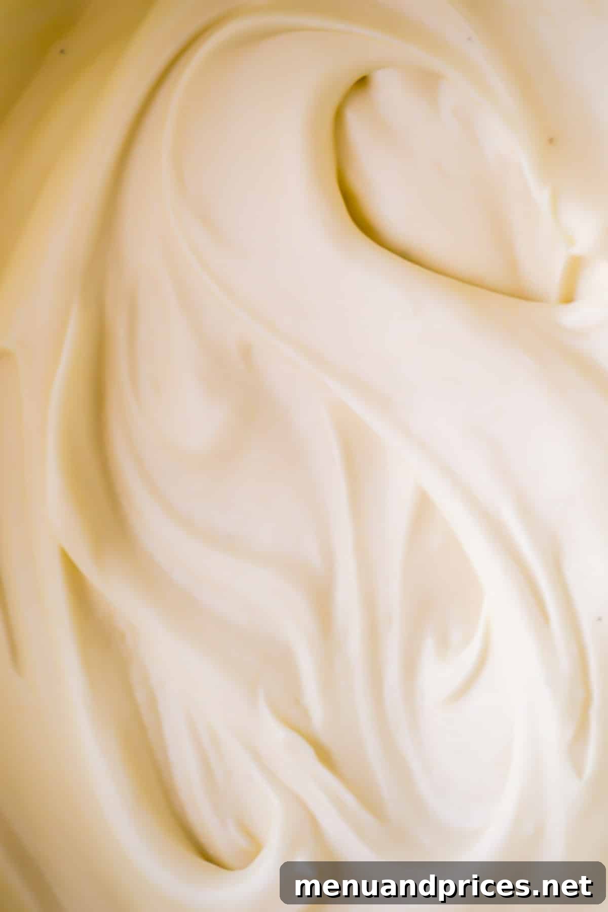 Effortless Cream Cheese Frosting Perfection 2 Upclose creamy smooth cream cheese frosting, showcasing its luxurious texture.