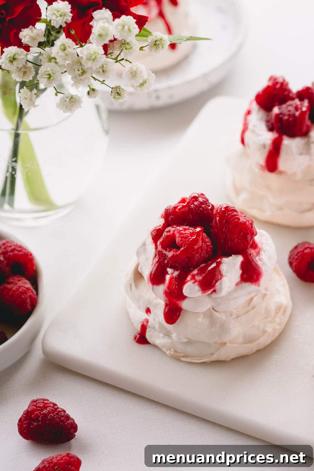 Petite Raspberry Pavlova Clouds 2 Mini pavlova topped with raspberry whipped cream, raspberry sauce and fresh raspberries.