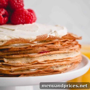 a crepe cake with whipped cream and raspberries on top.