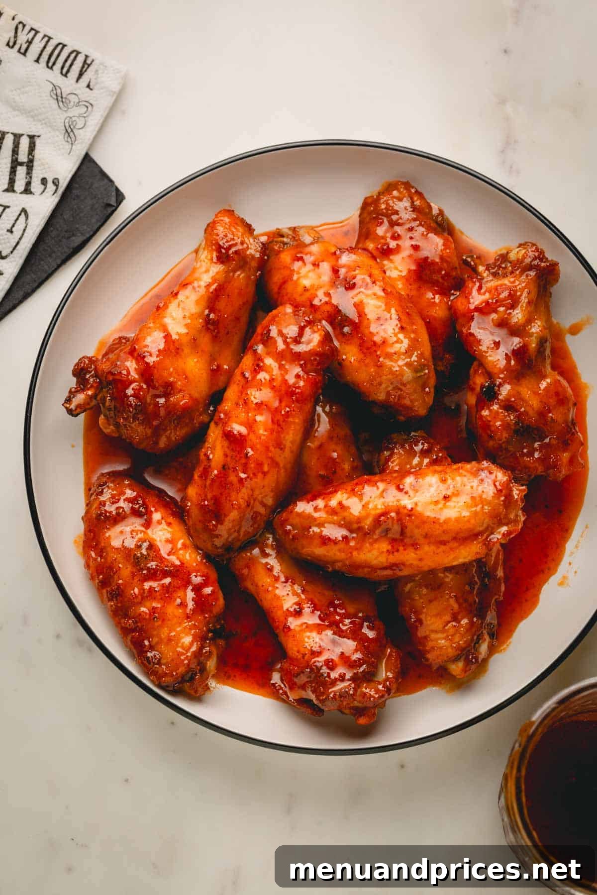 Sticky Sweet Heat Wings 13 A large bowl filled with perfectly glazed hot honey chicken wings.