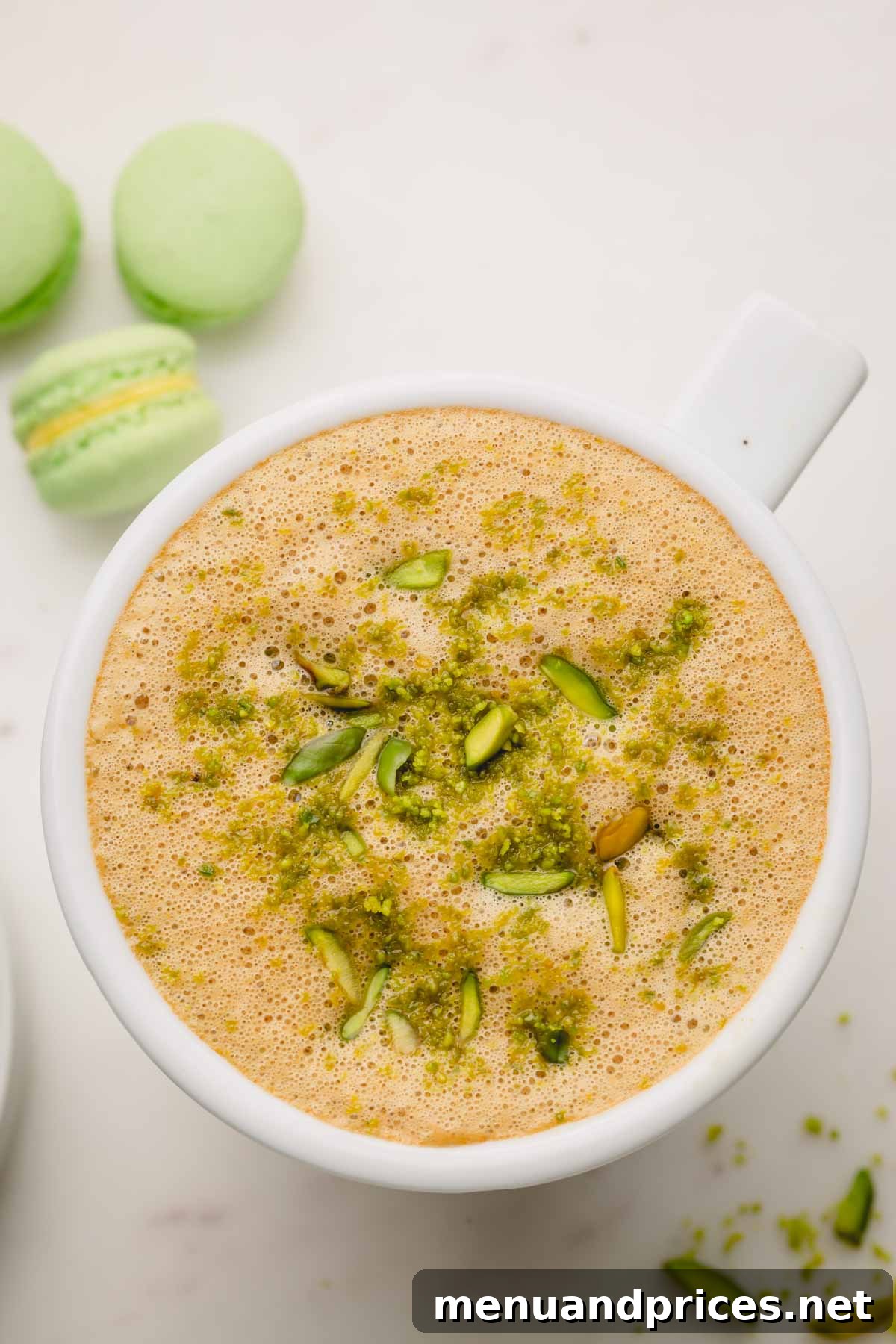 A pistachio latte topped with crushed pistachio.