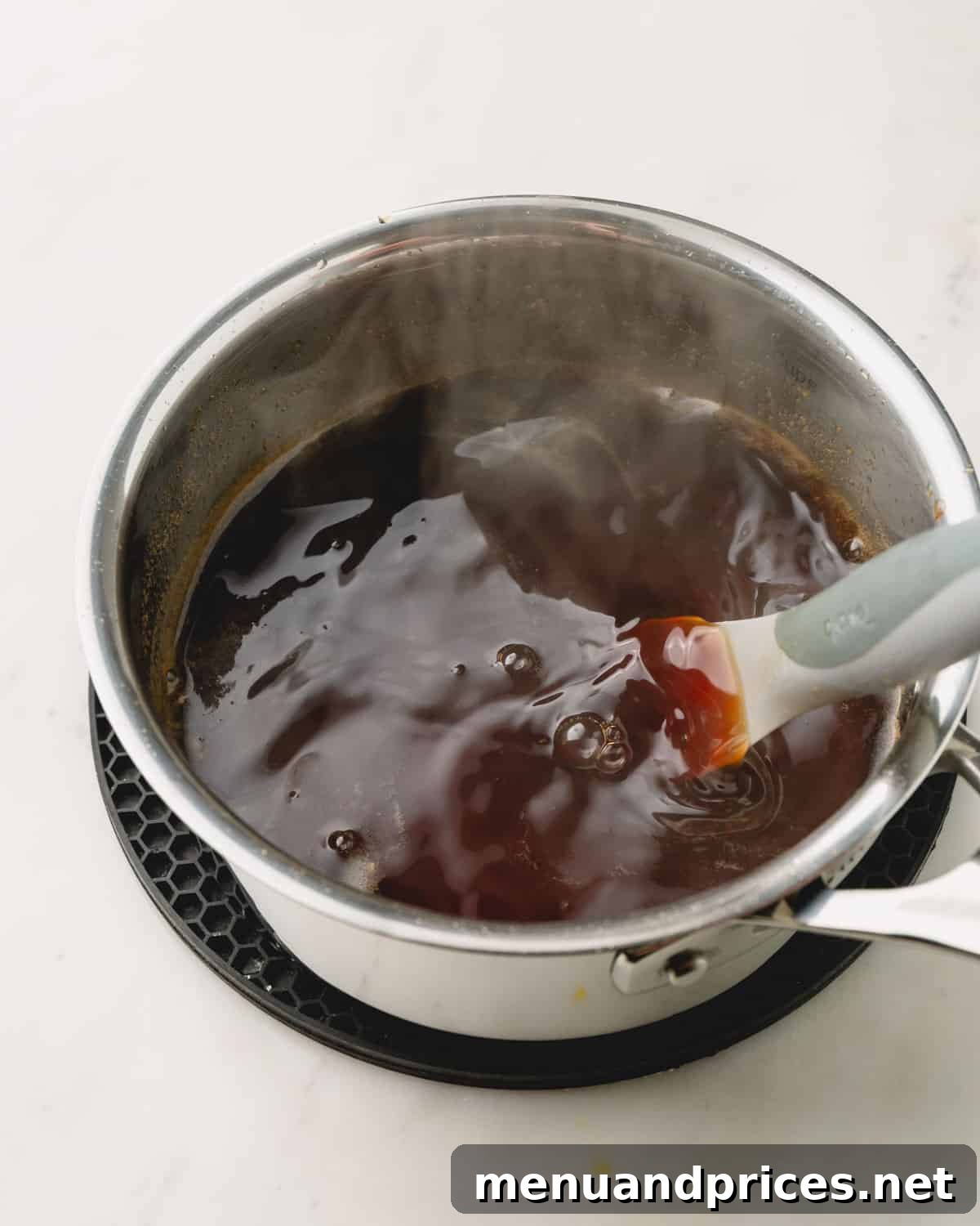 Sticky Honey Teriyaki 7 A pot of honey teriyaki sauce gently simmering on the stove, beginning to thicken.