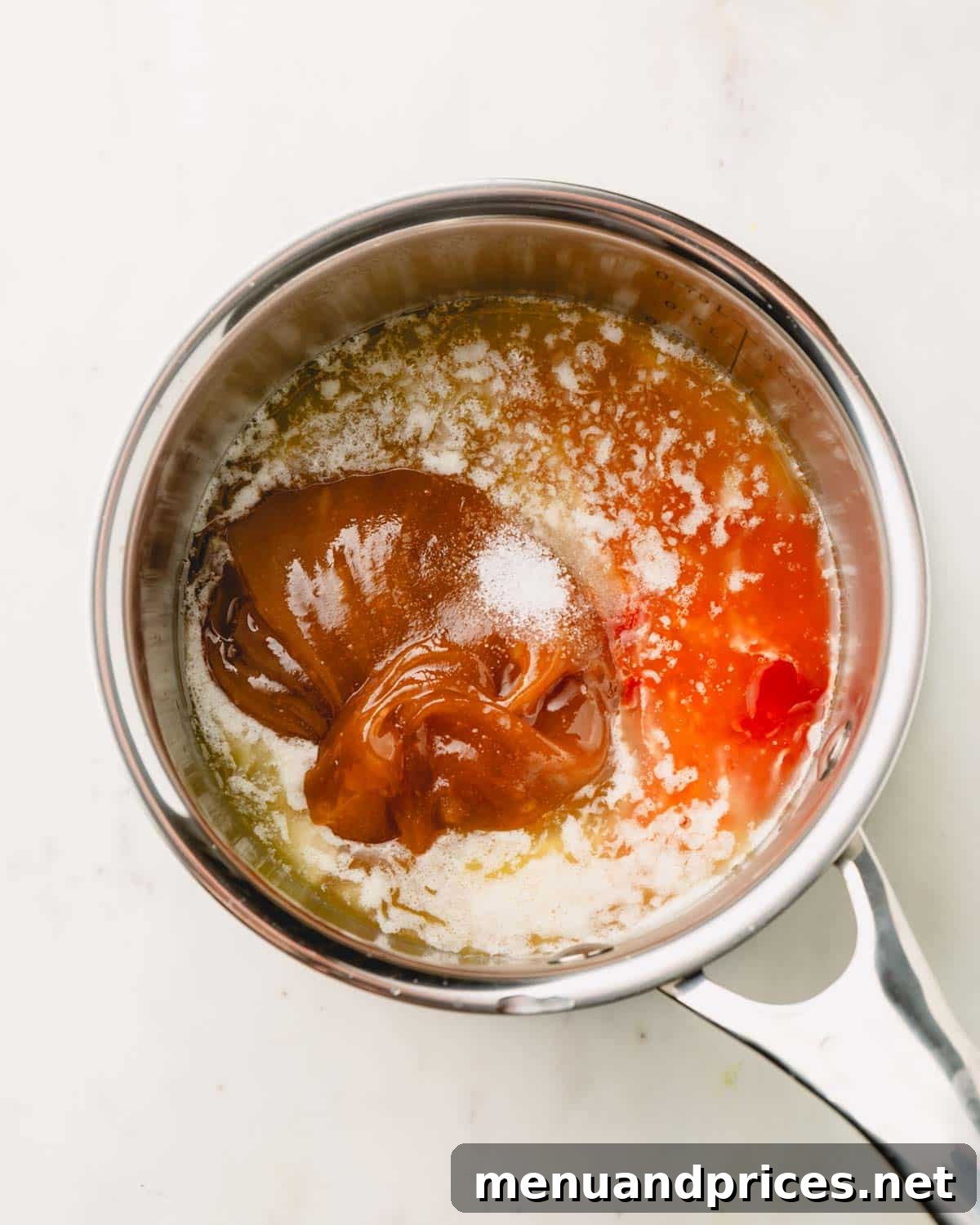 Golden Blaze Drizzle 5 Honey, hot sauce, and salt added to melted butter in a pot, ready for stirring.