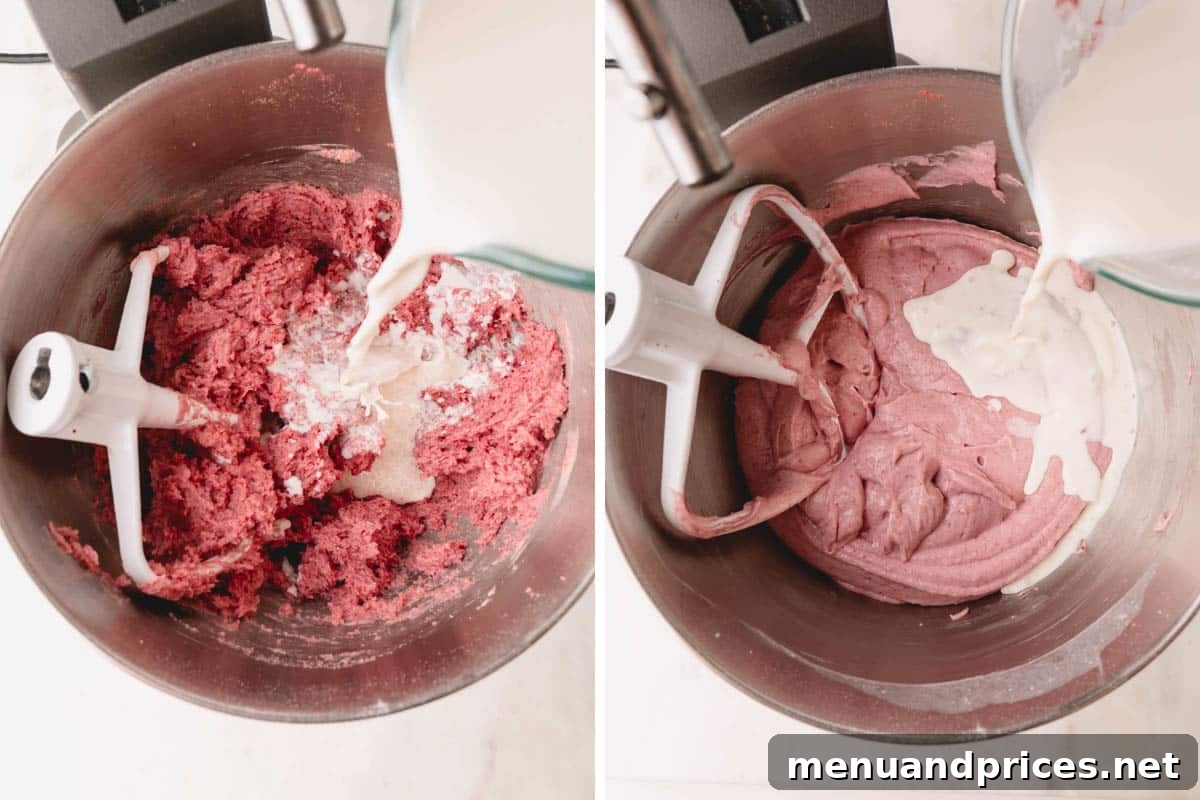 Sweet Strawberry Dream 11 Strawberry cake batter being mixed in a stand mixer, demonstrating the gradual incorporation of the liquid ingredients until smooth.