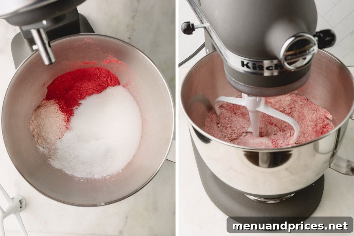 Sweet Strawberry Dream 8 Dry ingredients for the strawberry cake, including strawberry powder, flour, sugar, baking powder, and salt, being gently combined in a stand mixer bowl using a whisk attachment.