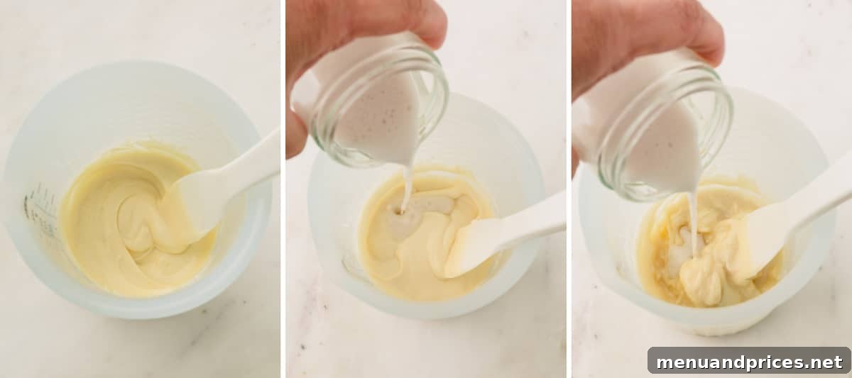 Strawberry Silk Dairy Free Ganache 6 Warmed coconut milk being slowly poured into a bowl of melted white chocolate, illustrating the beginning of the ganache emulsification process.
