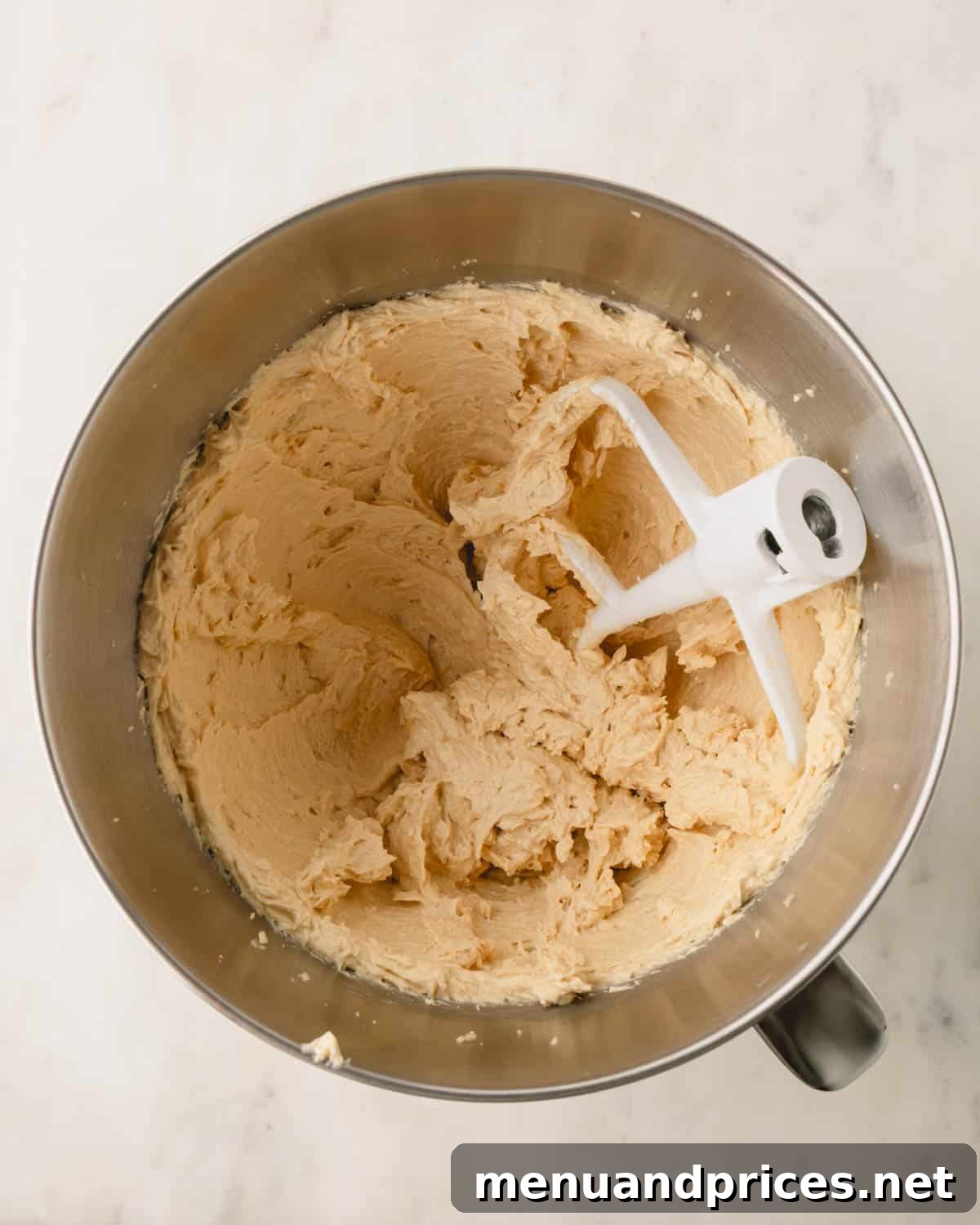 Decadent Thick and Chewy Chocolate Chip Cookies 9 A stand mixer bowl showing the wet ingredients smoothly combined into a cookie dough base.