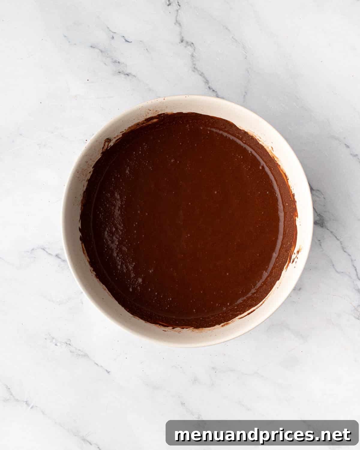 The smooth and glossy bloomed cocoa mixture in a bowl, ready to be incorporated into the cake batter.