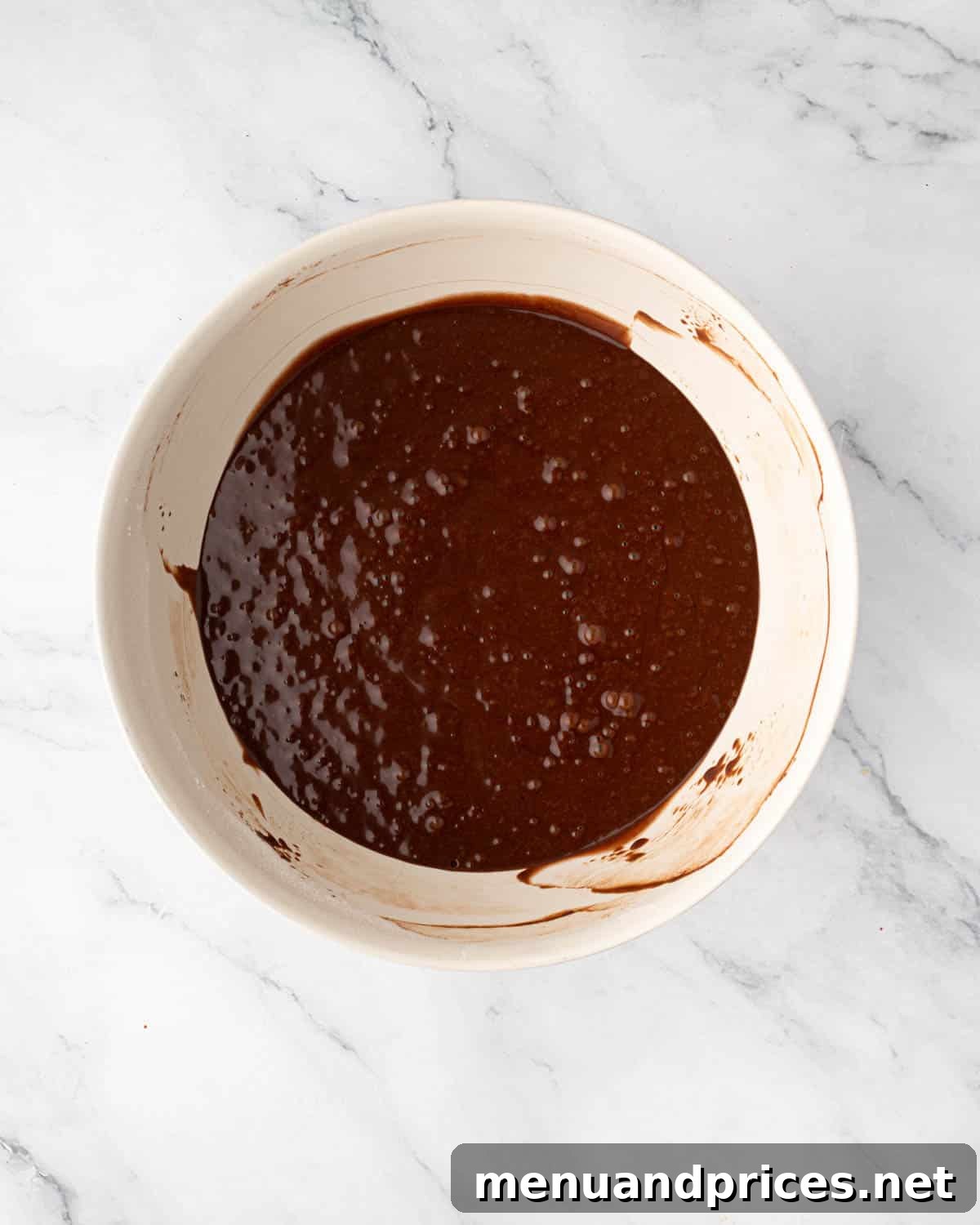 The fully mixed chocolate cake batter, smooth and ready for baking.