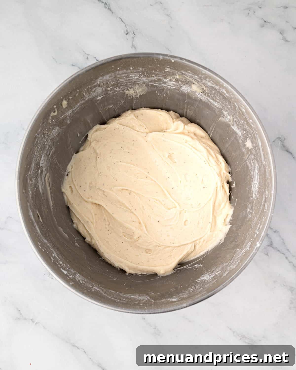 Crimson Velvet Brownies 16 Smooth and creamy cream cheese frosting in a mixing bowl, perfectly whipped and ready to be used.