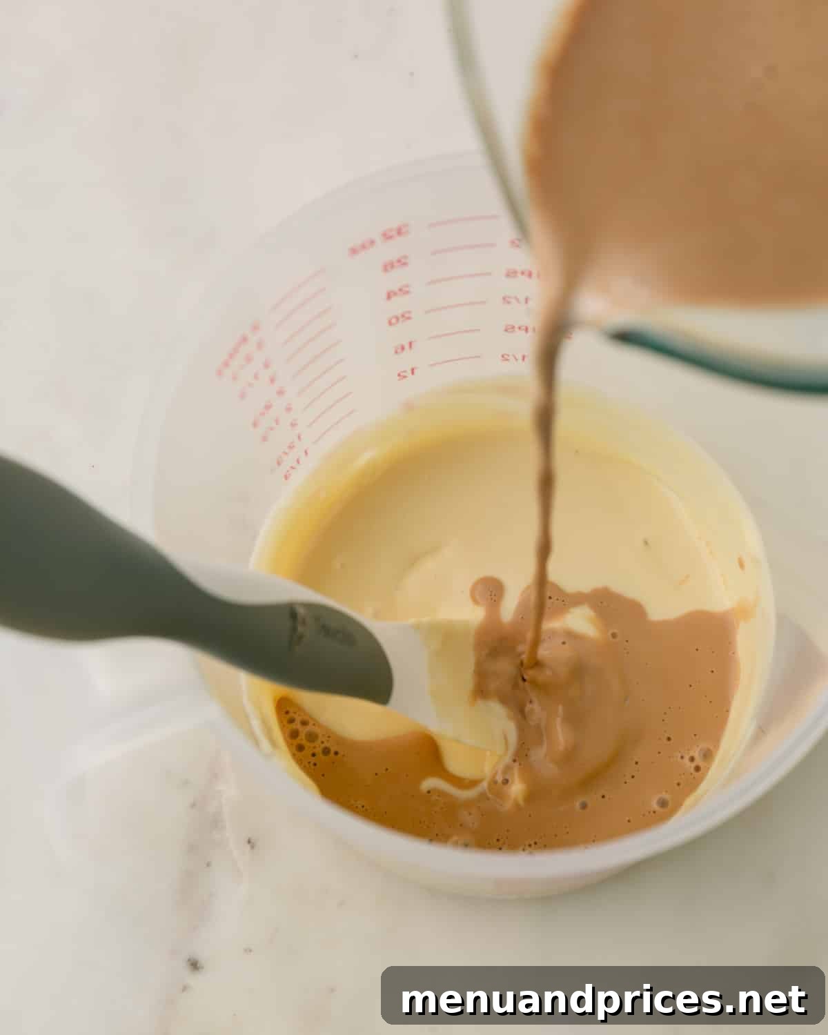 Espresso Dream Macarons 16 Espresso cream being poured into melted white chocolate.
