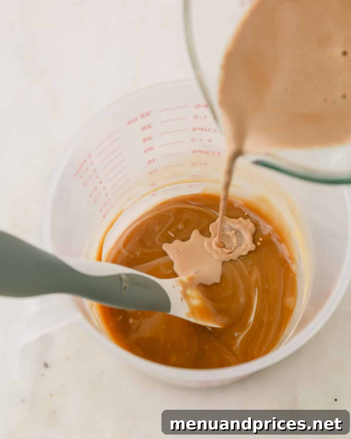 Espresso Dream Macarons 17 More espresso cream being poured into the melted white chocolate.