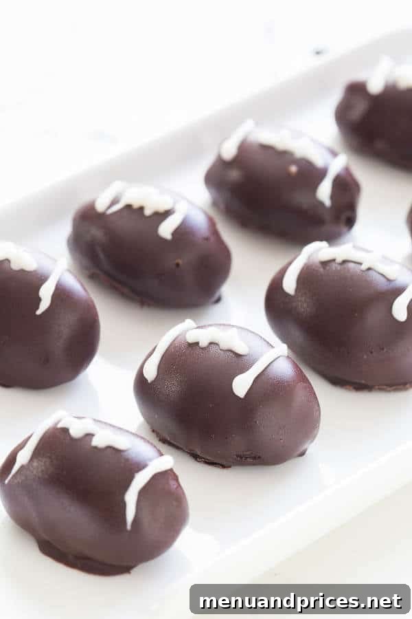 Decadent No-Bake Triple Chocolate OREO Truffles 4 Football-shaped Triple Chocolate OREO Cookie Balls arranged on a platter for a festive party